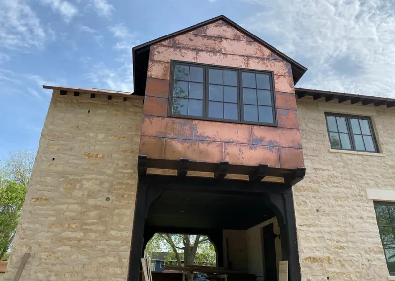 Copper metal panel facade on a stone building for Skylight Installation in Ham Lake